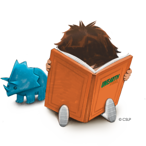 small child reading an orange covered book next to a small blue triceratops